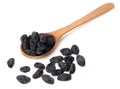 black raisins in wooden spoon isolated on white background Royalty Free Stock Photo