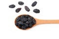 black raisins in wooden spoon isolated on white background. top view Royalty Free Stock Photo