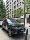 Black Range Rover car stands in front of a high-rise building Royalty Free Stock Photo