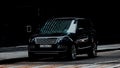 Black Range Rover L405 car parked on street. Front side view of slylish luxury SUV Royalty Free Stock Photo