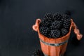 Black raspberries in a wooden basket on background. Frame. Copy space. Top view. Royalty Free Stock Photo