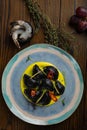 Black ravioli with seafood on a wooden background