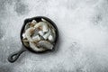 Black raw tiger shrimps, in cast iron frying pan, on gray stone background, top view flat lay, with copy space for text Royalty Free Stock Photo