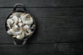 Black raw tiger shrimps, in cast iron frying pan, on black wooden background, top view flat lay, with copy space for text Royalty Free Stock Photo