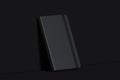 Black realistic notepad isolated on dark background. 3d rendering.