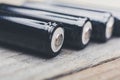 Black Rechargeable LR6 AA 1.5V Batteries On A Wooden Table Royalty Free Stock Photo