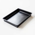 Black rectangular baking pan on white surface suitable for cooking and baking tasks