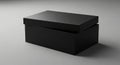 A black rectangular box with a slightly open lid rests on a smooth, neutral gray surface. The box Royalty Free Stock Photo