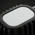 A black, rectangular object with a glossy white surface and ribbed edges, creating Royalty Free Stock Photo
