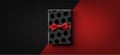 Black rectangular polka-dot gift box with red bow