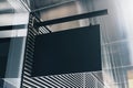 Black rectangular sign on the wall of a modern shopping mall, mock up