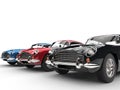 Black, red and blue classic vintage cars in a row Royalty Free Stock Photo