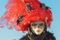 Black and red costumed masked woman portrait