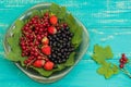 Black, red currant and strawberries on old background. Top view. Close-up Royalty Free Stock Photo