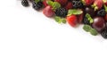 Black and red food at border of image with copy space for text. Ripe blackberries, strawberries, plums on white background. Top vi Royalty Free Stock Photo