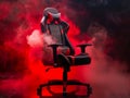 A black and red gaming chair in a dark room Royalty Free Stock Photo