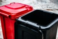 Black and red garbage containers for separation and sorting  Glass, plastic, paper and household waste. Royalty Free Stock Photo