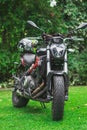 Black and red modern motocycle in the grass with helmet