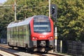 Black and red NS Albellio Flirt train of the R-Net train on the track