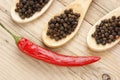 Black and red pepper in wooden spoon Royalty Free Stock Photo