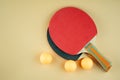 Black and red Ping pong rackets and three orange balls Royalty Free Stock Photo