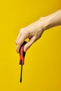 Black and red screwdriver isolated on yellow background Royalty Free Stock Photo