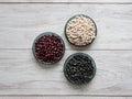 Black, red and white beans flat lay on a table. Royalty Free Stock Photo