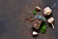 Black, red and white pepper in a glass jar, garlic and parsley. Classic spices for cooking. View from above Royalty Free Stock Photo