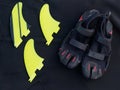 Black reef shoes with fins on a wetsuit.
