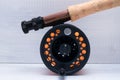 Black reel with orange fishing line on fishing rod close up on a light background Royalty Free Stock Photo
