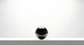 Black reflective sphere on a clean white surface Royalty Free Stock Photo