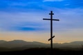 Black religion symbol silhouette Jesus Christ wooden cross on a background with colorful mountain sunset, Easter concept Royalty Free Stock Photo