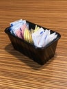 A black restaurant container with artificial sweeteners. Royalty Free Stock Photo