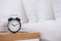 Black Retro alarm clock on table in bedroom at night, sleeping and daily routine concept Royalty Free Stock Photo