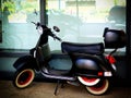 Black Retro Scooter with Red Wheels Royalty Free Stock Photo