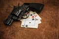 Black revolver and old playing cards