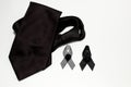 Black ribbon and black necktie; decoration black ribbon hand made artistic design for sadness expression isolated on white Royalty Free Stock Photo