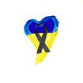 Black ribbon on a heart with the Ukrainian colors, symbol of support for the Ukrainian war dead Royalty Free Stock Photo