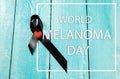 Black ribbon-symbol of fight against melanoma and skin cancer. Royalty Free Stock Photo