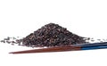 Black rice grains pile with chopsticks isolated Royalty Free Stock Photo