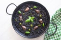 Black rice paella with seafood and fish. Traditional Spanish recipe. Royalty Free Stock Photo