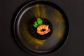 Black rice risotto with shrimp and safron in a black plate seen from above in dark background Royalty Free Stock Photo