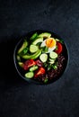 Black rice salad with vegetables, avocado, egg and spring onion Royalty Free Stock Photo