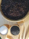 Black rice, black sesame, sugar, in a wooden dish, placed on a wooden tray. Royalty Free Stock Photo