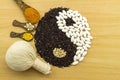 Black rice and white pill forming a yin yang symbol and Spa he