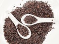 Black rice in white spoons Royalty Free Stock Photo
