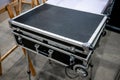 Black road case or flight case with wheels on metal stand for di