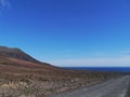 A black road in the colorful mountains on Fuerteventura