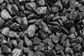 Black road stones gravel texture, rocks for construction, dark background of crushed granite gravel, small rocks, closeup