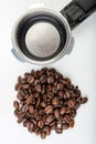 Black roasted coffee beans and a coffee machine flask. Coffee making accessories Royalty Free Stock Photo